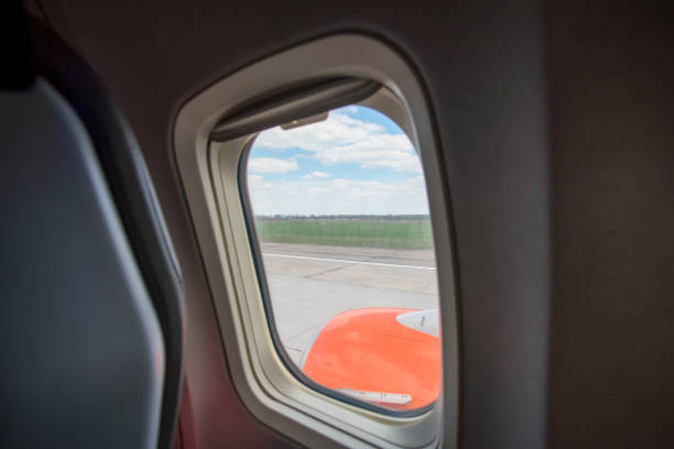 view from the airplane window to the blue sky and white clouds without people