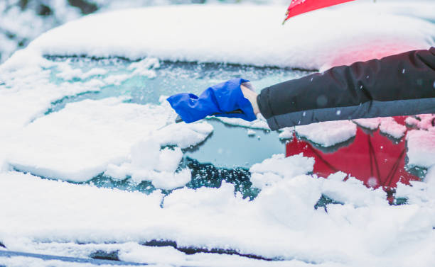 istock Person Clearing Snow From Car Windshield With Ice Scraper On Winter Morning 2186949765