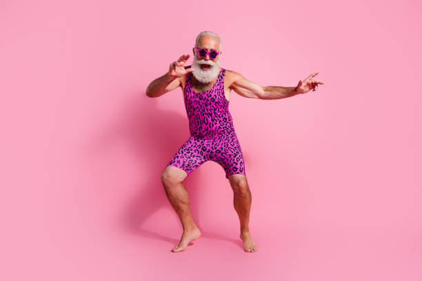 Full body photo of positive old man dancing good mood enjoy party wear glamour leopard print overall isolated pink color background Full body photo of positive old man dancing good mood enjoy party wear glamour leopard print overall isolated pink color background. gay man men sunglasses party stock pictures, royalty-free photos & images