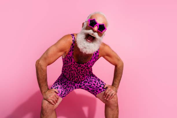 Photo of positive old man excited look camera dancing energetic wear glamour leopard print overall isolated pink color background Photo of positive old man excited look camera dancing energetic wear glamour leopard print overall isolated pink color background. gay man men sunglasses party stock pictures, royalty-free photos & images