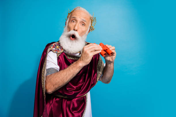 istock Photo of funny actor character hold binoculars enjoy performance antique theme party history isolated on blue color background 2186950737