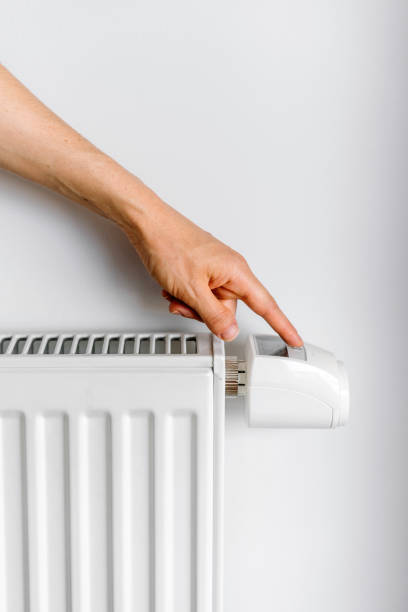 istock Control temperature with a modern electric heater in a cozy living space 2186953149