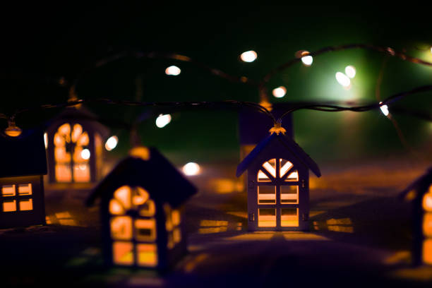 Colorful Christmas lights decorate a two-story house, yard and fence with a bright snowman and festive figures, creating a joyful holiday scene full of warmth and celebration.Brooklyn, NYC, USA