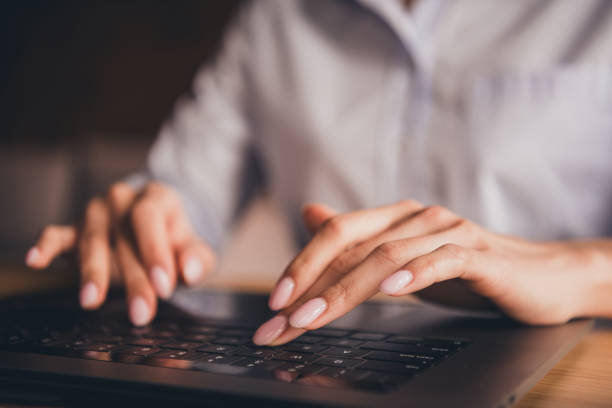 istock A young professional woman typing on a laptop in a modern office during daylight hours 2186954182