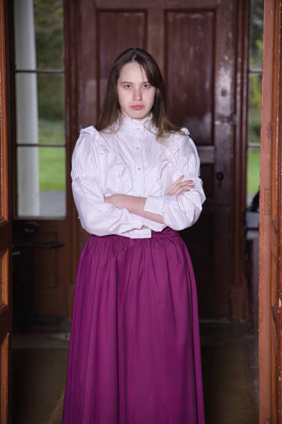 Young woman standing against a wall and posing alternatives.