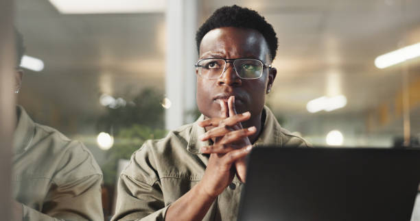 istock Business, thinking and black man with laptop, doubt and problem solving with website info. Person, journalist and employee with pc, internet and decision with choice, research for article and thought 2186954304