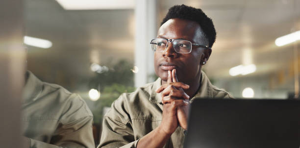 Business, thinking and black man with laptop, solution and research with website info. Person, journalist and employee with pc, internet and decision with choice, problem solving and idea for article