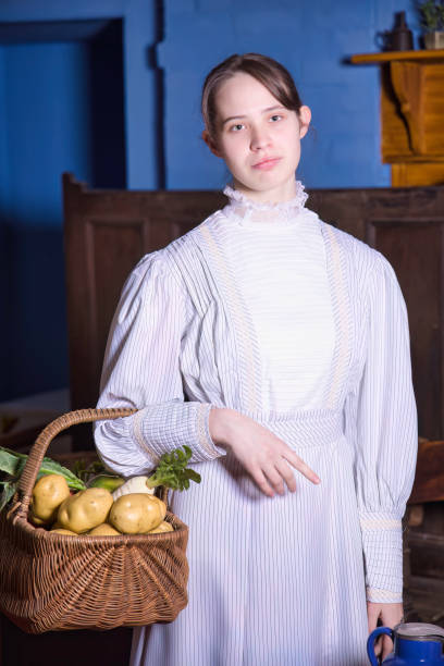 Reenactment teenager in a 1900s kitchen.