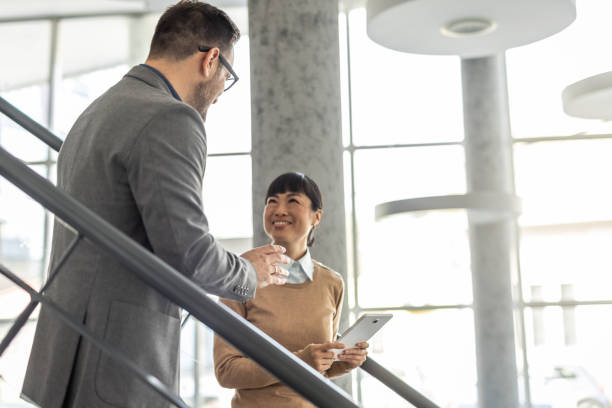 istock Multicultural Team - A Japanese woman and her team partner exchange ideas 2186956036