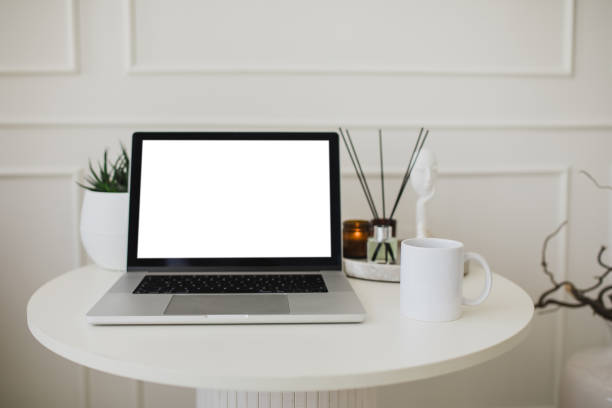 istock Laptop and white mug with tea on a table. Workspace in a modern room. 2186956037