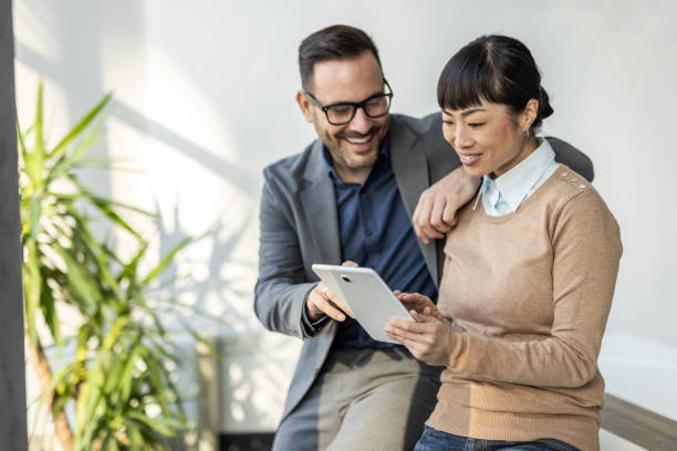 istock Team communication - Japanese woman and her colleague analyze data on a tablet 2186956042