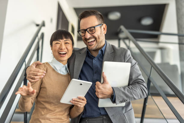 istock Two happy colleagues sharing a joyful moment 2186956045