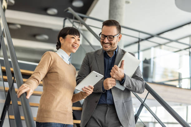 istock Multicultural Team - A Japanese woman and her team partner exchange ideas 2186956068