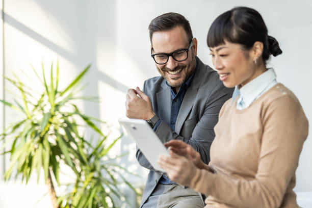 istock Team communication - Japanese woman and her colleague analyze data on a tablet 2186956081
