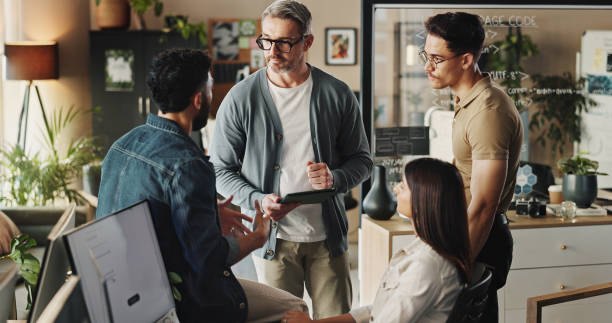 istock Teamwork, group of people and tablet in web design with collaboration, brainstorming and planning. Diversity, discussion and technology for project management, employee engagement and problem solving 2186957432