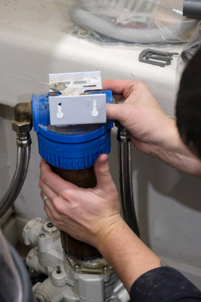 istock Replacement of a water softener filter cartridge by a technician, in a house. 2186957741