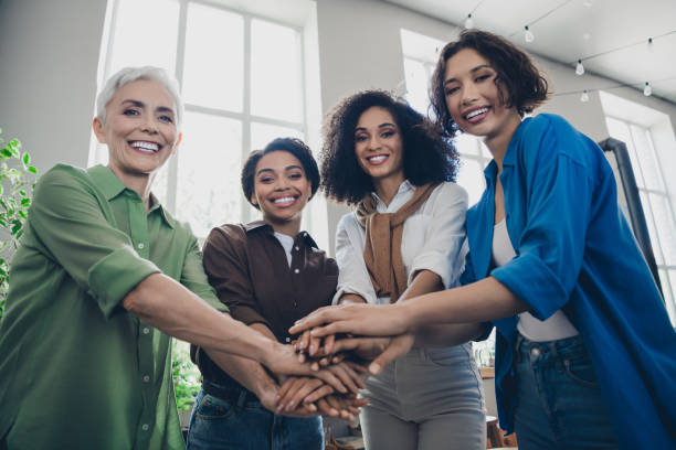 istock Photo of successful corporate women beaming smile pile stack hands modern interior office business center indoors 2186958247