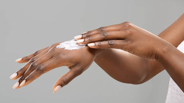 istock Hands of unrecognizable black woman with applied body lotion. 2186959622