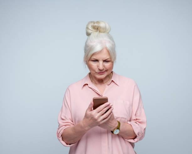 istock Displeased senior lady using phone 2186961950