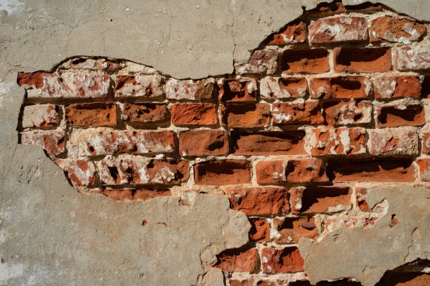 istock old brick wall with layers of old plaster and paint, background 2186962596