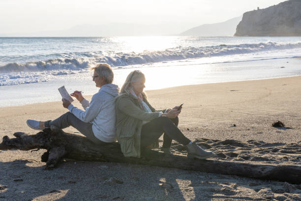 istock Mature couple relax on beach at sunset in autumn 2186965227