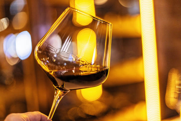 istock Elegant Wine Glass Held Against a Warm Blurred Background 2186968456