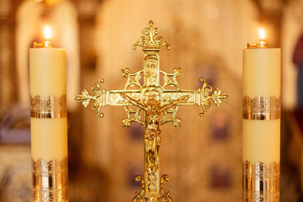 istock Candles glowing near a golden cross 2186968812