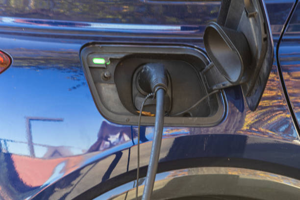 istock harging indicator on electric car's port with cable connected. 2186970364