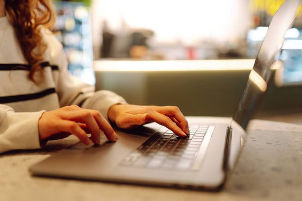 istock Close-up of hands working on a laptop keyboard. 2186970650