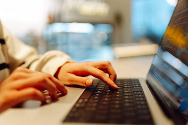 istock Close-up of hands working on a laptop keyboard. 2186970740