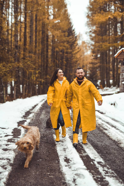istock Joyful Couple Wandering Through Forest With Their Dog Walking in Front of Them 2186971749