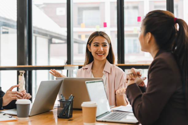 istock group of professionals engaged in lively discussion at modern office setting, showcasing collaboration and teamwork. atmosphere is positive and dynamic, reflecting productive work environment 2186974664