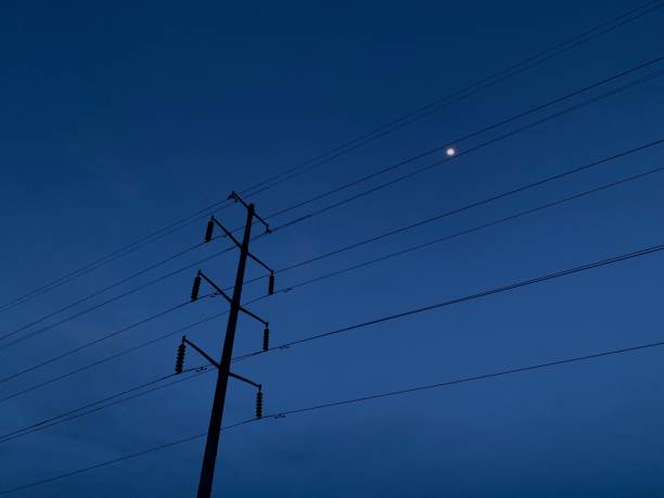 istock Power Lines Against Night Sky 2186975803