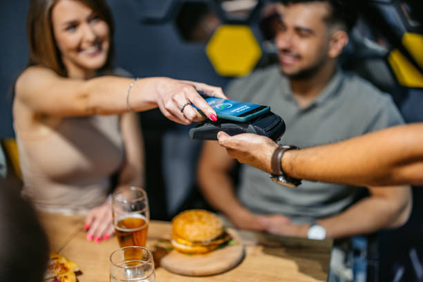 istock Young Woman Paying Via Contactless Channel By Mobile Banking Application 2186976628