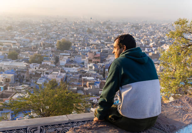 istock young man looking crowded city view from mountain top at morning 2186978598