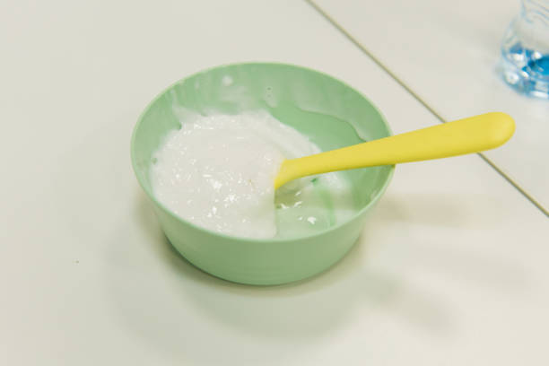 istock The child prepares a slime in a cup. 2186978726