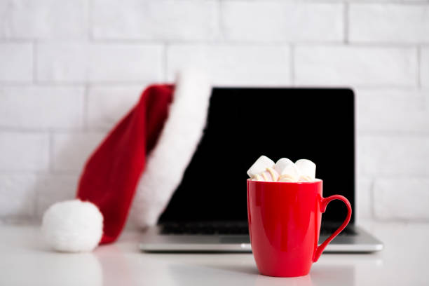 istock Workplace with laptop and hot cocoa with marshmallow 2186979844