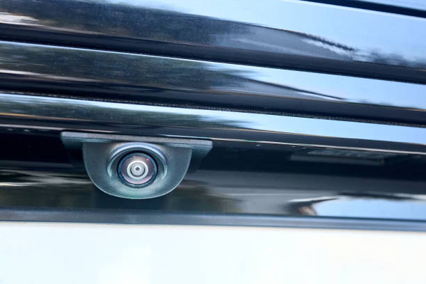 istock Car rear view camera parking sensor accessory reverse back new vehicle spycam with waterdrops. Luxury car rear view camera close up for parking assistance. Concept of safety car driving while parking 2186979933
