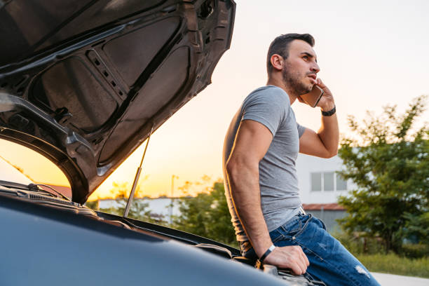 istock Mid-Adult Man Calling Road Assistance While Having Car Problems On The Street 2186981947