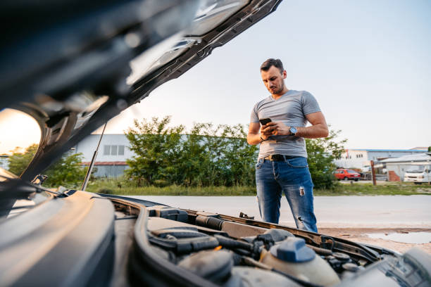 istock Mid-Adult Man Calling Road Assistance While Having Car Problems On The Street 2186981960