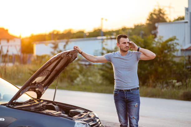 istock Mid-Adult Man Calling Road Assistance While Having Car Problems On The Street 2186981968