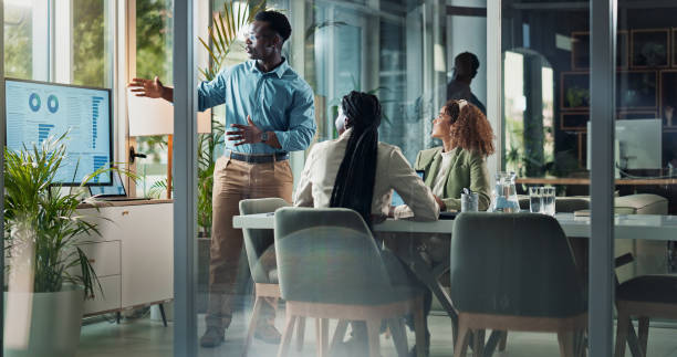 istock Meeting, presentation and man in office with statistics for planning, strategy data and ideas. Growth, development or business people in conference room for discussion, advice and team sales analysis 2186982814