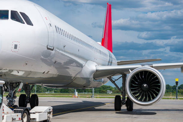 istock Towing truck pulling white aircraft  at the airport 2186983149