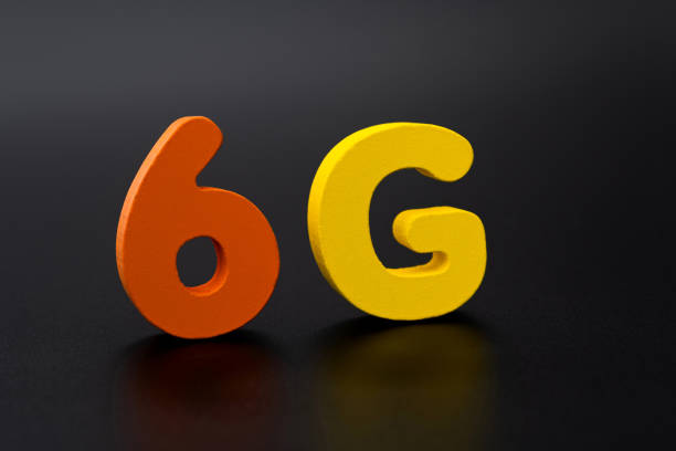 Wooden word 6G on black background.