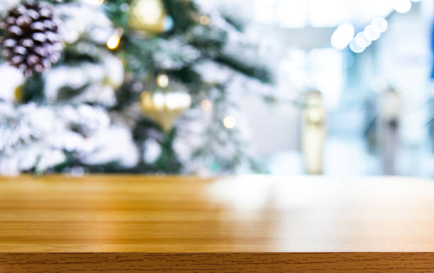 istock Empty wooden table over defocused christmas ornaments background 2186986645