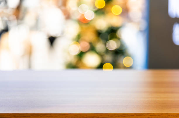 istock Empty wooden table over defocused christmas ornaments background 2186986664