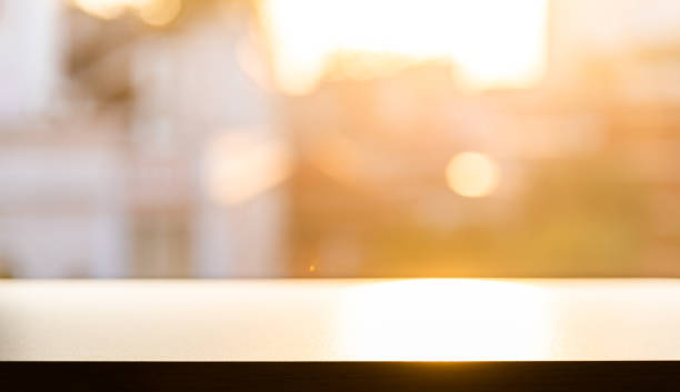 Empty wooden table in front of abstract blurred bokeh background of restaurant