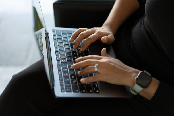 istock Businesswoman working remotely on laptop, typing on keyboard 2186987403