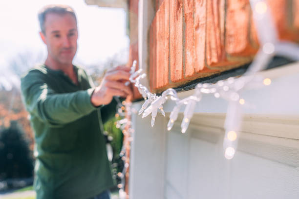 istock Soft Focus Artistic Image of a Mid-Age Man Hanging Christmas Lights 2186987550