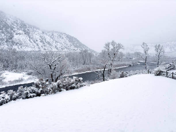 Snowstorm and Winter View of River - Scenic Eagle River with several inches of fresh snow and snowing. Eagle River, Western Colorado USA.